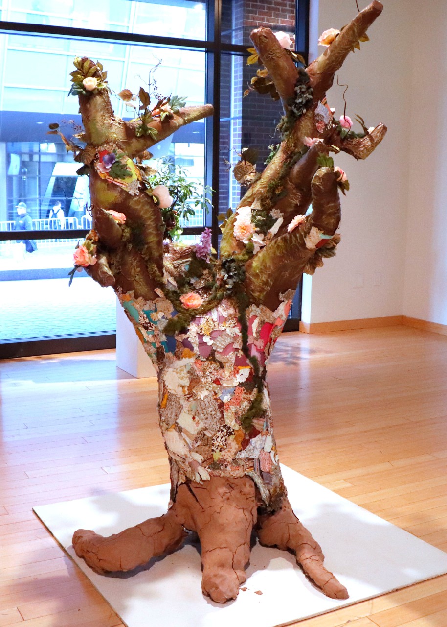 Houseplant by Nicole Moore, Jennah Hughes, Abbie Werner, Hannah Bundschuh, Recycled materials, paint cans, caulk, primer, paint swatches, fake flowers, fake moss, hot glue, metal, 2021